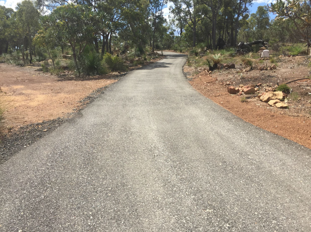 This is a photo of a hot spray & seal bitumen driveway which is in the process of being installed by Albury Surfacing Solutions