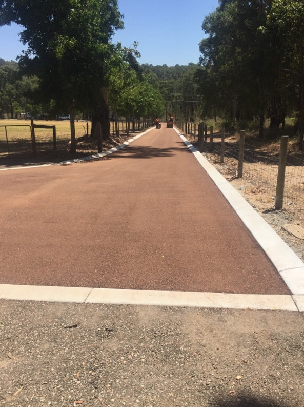 This is a photo of a hot spray & seal bitumen roadway which is in the process of being installed by Bendigo Surfacing Solutions